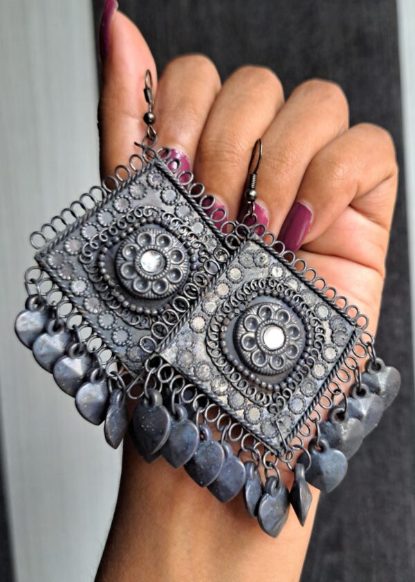 Chhaya Oxidised Earrings with large square design, black finish, and dangling heart-shaped details