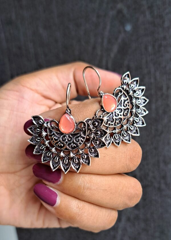 Pankhuri Pink Oxidised Earrings with intricate floral pattern, detailed metalwork, and teardrop-shaped pink stone