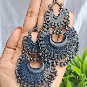 Crescent-shaped oxidised earrings with intricate detailing, inspired by traditional Indian craftsmanship.