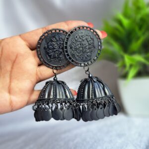 black oxidised jhumka earrings with intricate circular tops and dangling bell-shaped charms.