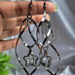 Ultra-light black earrings with a unique twist design and delicate star accents.