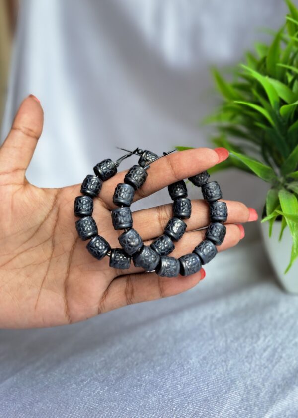 Paridhi Oxidised Hoop Earrings with bold, textured barrel-like beads and a latch closure, showcasing intricate oxidised details.