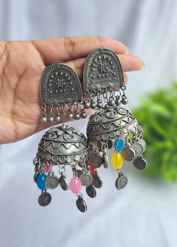 Oxidised jhumka earrings with intricate detailing and vibrant beads, ideal for festive outfits.